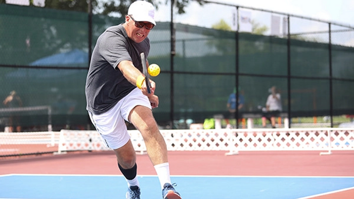 A pickleball player at the net
